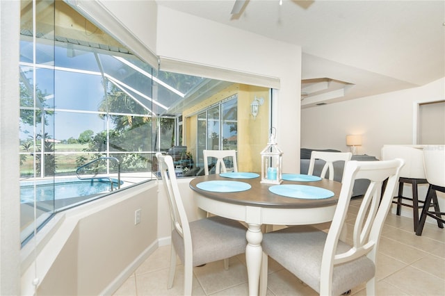 dining space featuring light tile patterned floors, a sunroom, and a ceiling fan