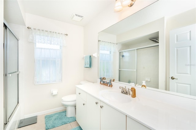 full bathroom with plenty of natural light, toilet, tile patterned flooring, and vanity