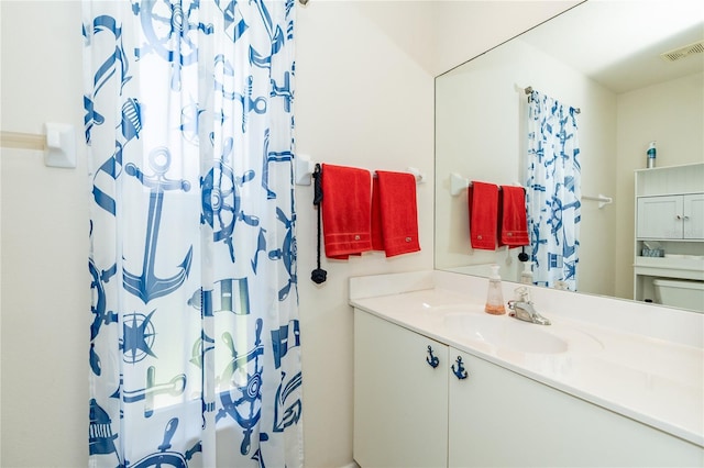 bathroom featuring shower / tub combo, visible vents, and vanity