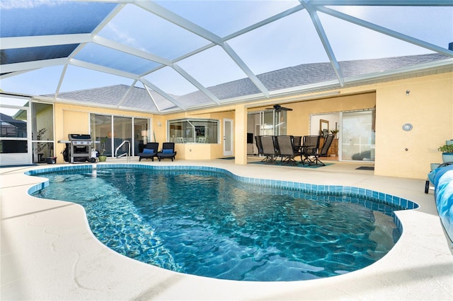 outdoor pool featuring ceiling fan, glass enclosure, outdoor dining space, and a patio