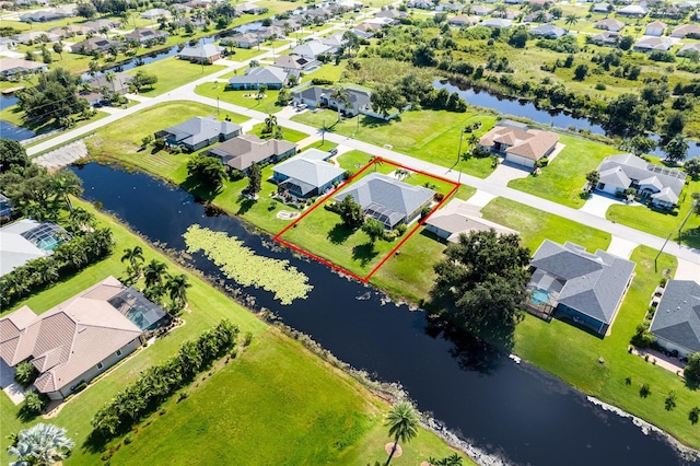 birds eye view of property featuring a residential view and a water view