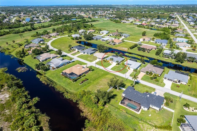 drone / aerial view featuring a water view and a residential view