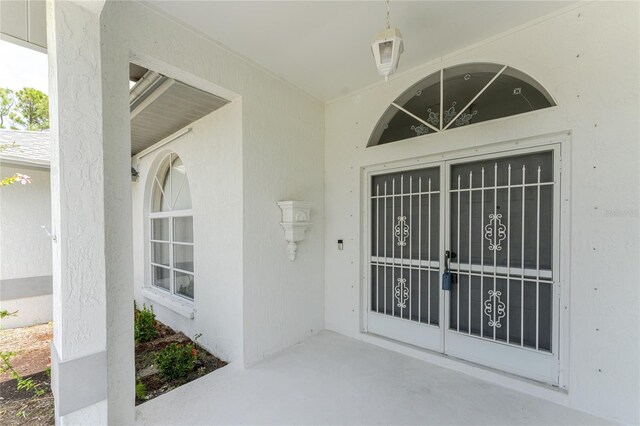 entrance to property featuring stucco siding