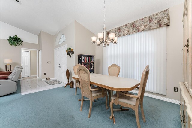 tiled dining room with vaulted ceiling and a chandelier