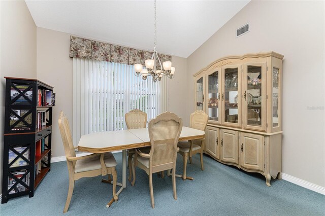 carpeted dining area with a notable chandelier and vaulted ceiling