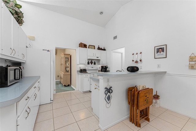 kitchen featuring high vaulted ceiling, white cabinetry, white appliances, light tile patterned floors, and kitchen peninsula