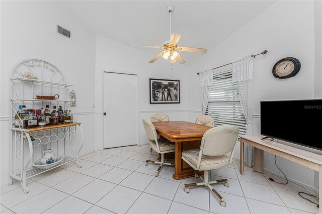 dining space featuring light tile patterned floors, ceiling fan, and lofted ceiling