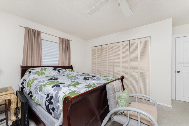 carpeted bedroom with a closet and ceiling fan