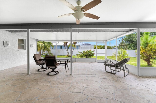 sunroom featuring ceiling fan