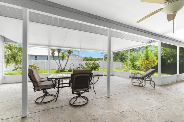 sunroom / solarium featuring ceiling fan