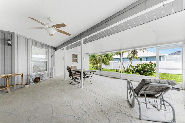 sunroom / solarium featuring ceiling fan and a wealth of natural light