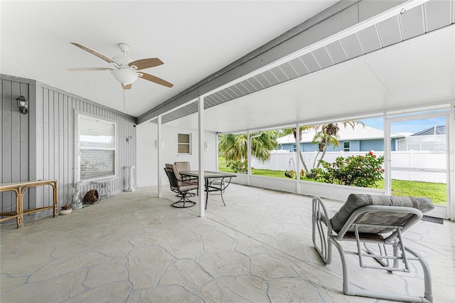 sunroom featuring ceiling fan and vaulted ceiling