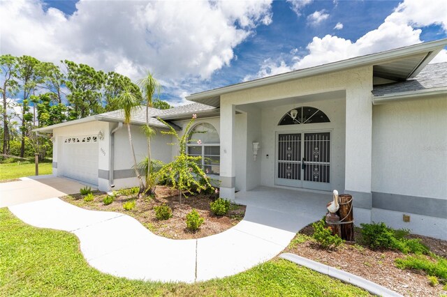 view of exterior entry with a garage