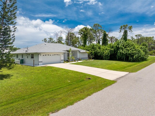 ranch-style house with a garage and a front lawn