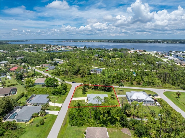 birds eye view of property with a water view