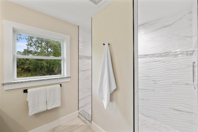 bathroom with a tile shower