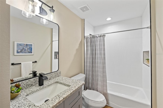 full bathroom featuring shower / tub combo, vanity, and toilet