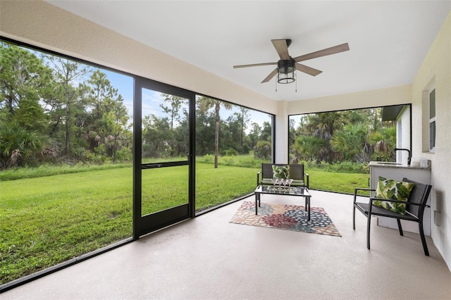 sunroom featuring ceiling fan