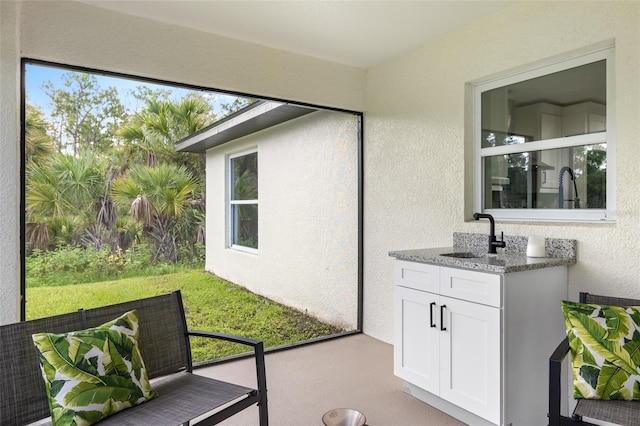 sunroom / solarium featuring sink