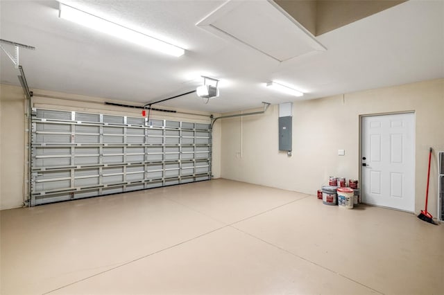 garage featuring electric panel and a garage door opener