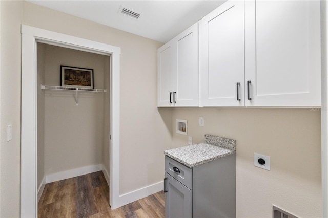 laundry room featuring cabinets, hookup for a washing machine, electric dryer hookup, and dark wood-type flooring