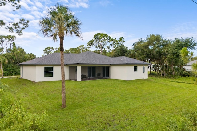 back of house featuring a yard and a sunroom