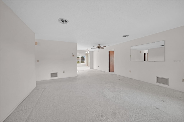 interior space featuring a ceiling fan, light colored carpet, and visible vents