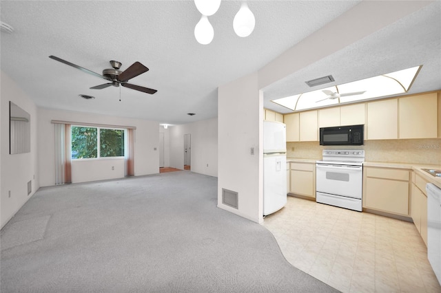 kitchen featuring open floor plan, light countertops, white appliances, and visible vents