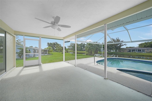 unfurnished sunroom with a ceiling fan