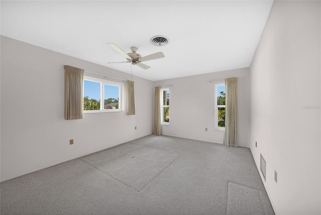 empty room featuring a ceiling fan and visible vents