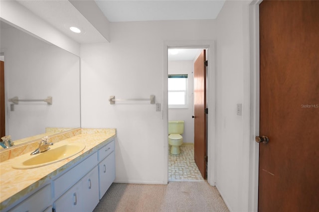 bathroom with toilet and vanity