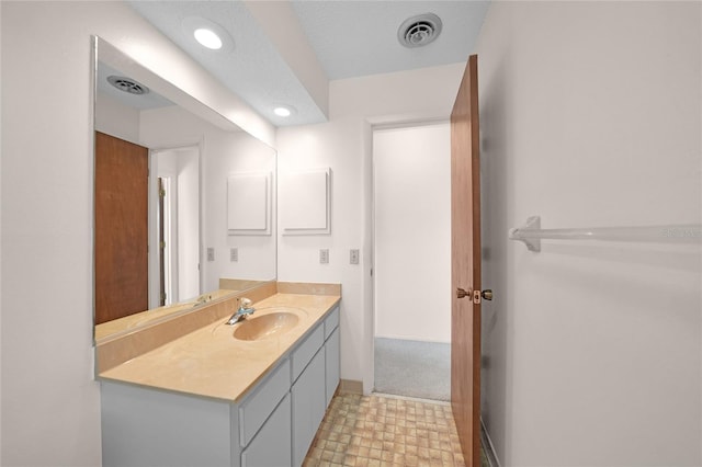 bathroom with tile patterned floors, recessed lighting, visible vents, and vanity