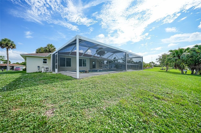 back of house with stucco siding, glass enclosure, an outdoor pool, and a lawn