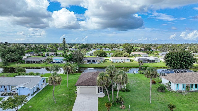 birds eye view of property with a water view and a residential view