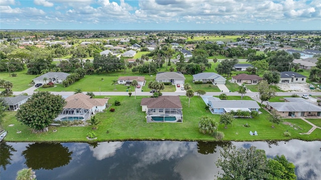 bird's eye view featuring a water view and a residential view