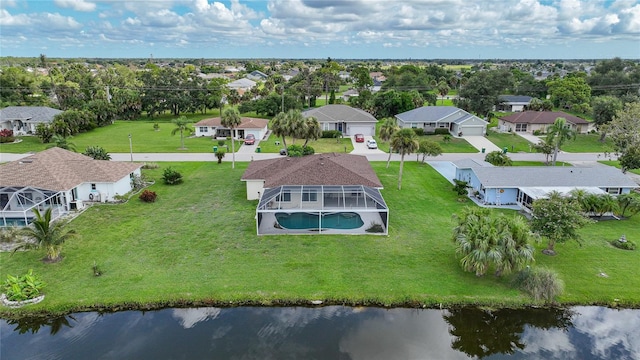 drone / aerial view featuring a water view and a residential view