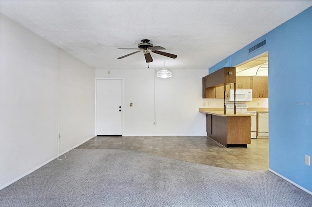 unfurnished living room featuring ceiling fan, a textured ceiling, and light carpet