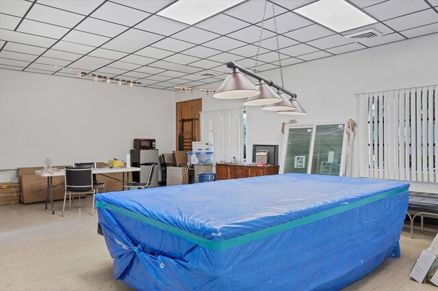 bedroom with pool table and multiple windows