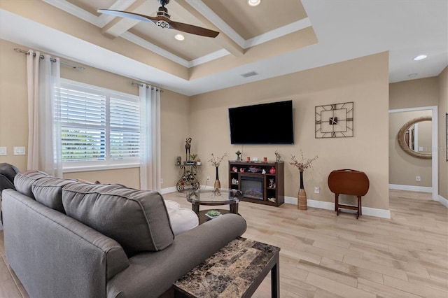 living room with ceiling fan, light hardwood / wood-style flooring, coffered ceiling, and a tray ceiling