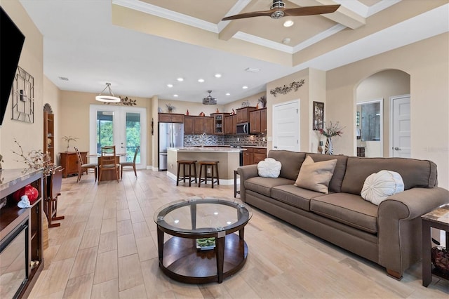 living room with coffered ceiling, crown molding, ceiling fan, sink, and french doors