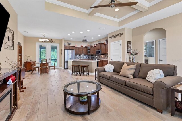 191 Brig Cir W, Placida, FL 33946 - living room with french doors, a ceiling fan, light wood finished floors, beamed ceiling, and arched walkways