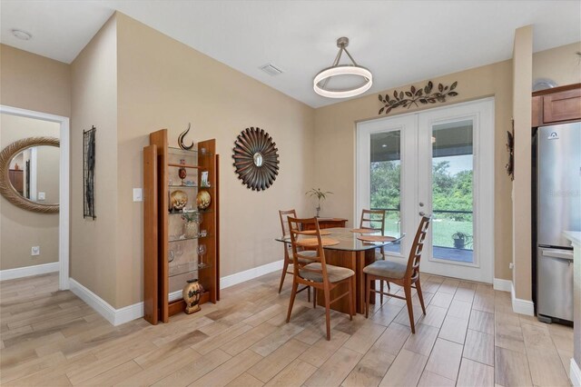191 Brig Cir W, Placida, FL 33946 - dining room featuring baseboards, visible vents, light wood-style flooring, and french doors