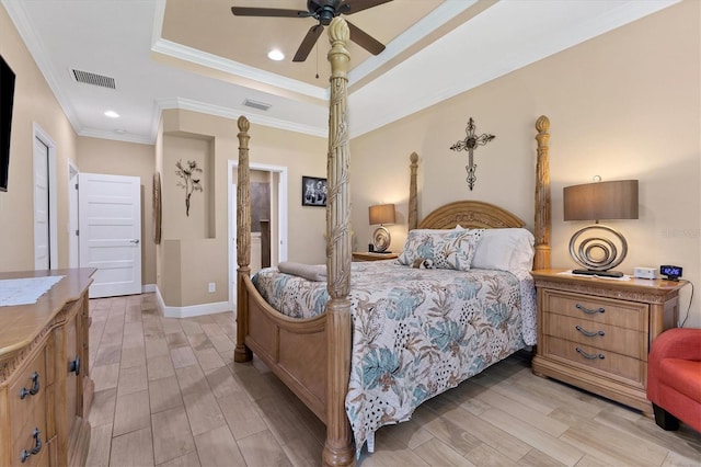 bedroom featuring ceiling fan, a raised ceiling, connected bathroom, and ornamental molding