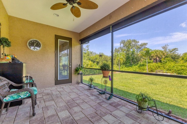 sunroom / solarium featuring ceiling fan