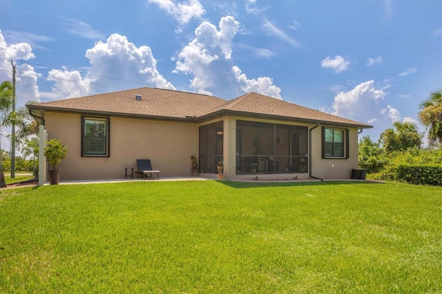 rear view of property with a sunroom and a lawn