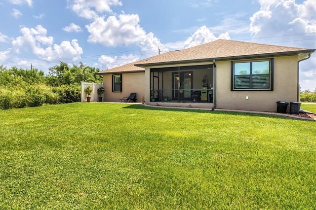 back of house with a sunroom and a yard