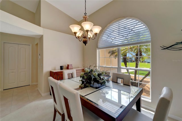 tiled dining room featuring high vaulted ceiling and a chandelier