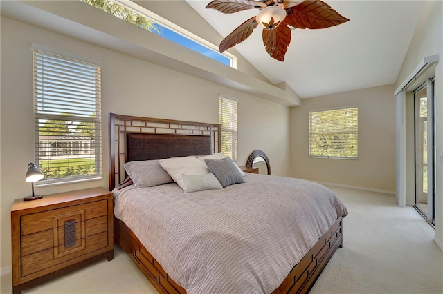 bedroom with ceiling fan, vaulted ceiling, light colored carpet, and multiple windows