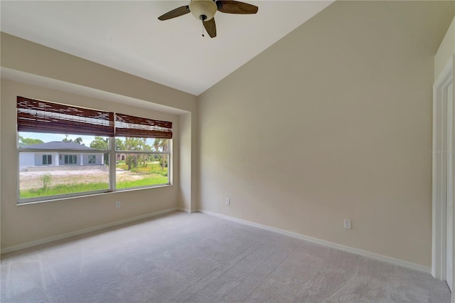 carpeted empty room with ceiling fan and lofted ceiling