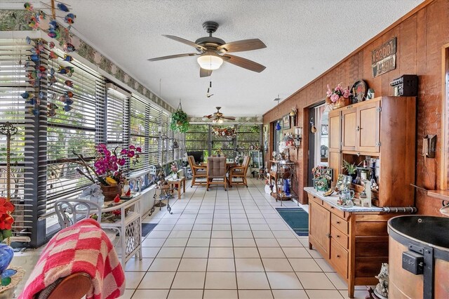 sunroom / solarium featuring ceiling fan